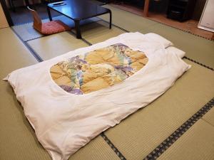 Postel nebo postele na pokoji v ubytování Ryokan Sanoya