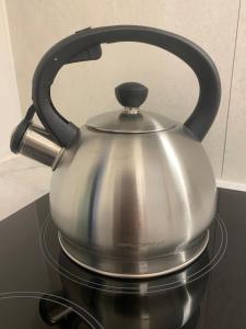 a silver tea kettle sitting on top of a stove at Monjan II Luxury Square Market Rynek in Wrocław