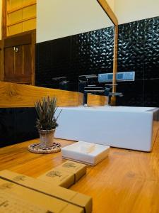 a bathroom with a white sink and a table at Sigiri Vananthara in Sigiriya +121 photos
