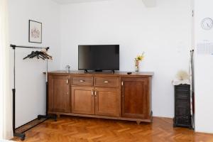 a television on a wooden cabinet in a room at Apartment Matic Sonkovic in Skradin