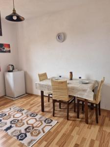 a dining room with a table and chairs and a refrigerator at Onur Apartment 's in Prizren +19 photos