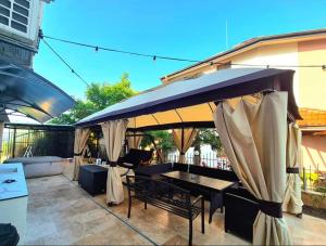 a patio with a table and an umbrella at Ivon Apartments in Sozopol