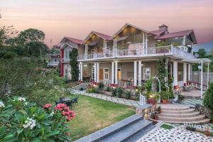 an image of a house with a garden at StayVista at SilverOaks Cottage in Dehradun