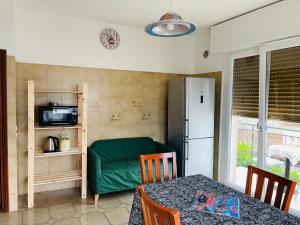 a kitchen with a green couch and a refrigerator at Casa Viktoria in Malcesine +12 photos