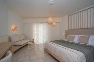 a bedroom with a large bed and a couch at Arkadia Hotel in Kipseli +158 photos