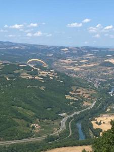 an aerial view of a city with a river and a bridge at La maison d autrefois in Aguessac