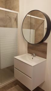 a bathroom with a white sink and a mirror at Studio en plein centre Valence in Valence