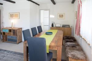 a dining room with a wooden table and chairs at Ski in Ski out Family accommodation Chesa Katja Lenzerheide in Valbella