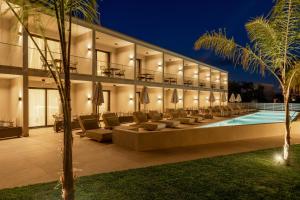 an exterior of a building with a swimming pool at Thera luxury living in Nikiti