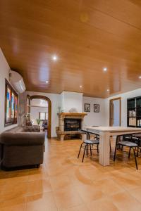 a large living room with a table and a couch at Villa Rural Avril in Camarles