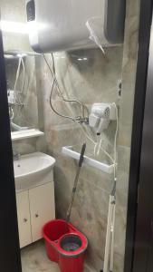 a bathroom with a mop in a bucket next to a sink at Beta Residence Saturn in Mangalia +18 photos