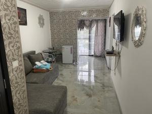a living room with a couch and a floor at Beta Residence Saturn in Mangalia