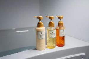 four bottles of essential oils sitting on top of a sink at Tanimachi Namba East43 in Osaka +27 photos
