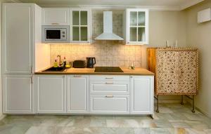 a kitchen with white cabinets and a counter top at Casa Veranera Vera Costa in Playas de Vera