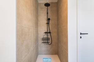a shower with a shower head in a bathroom at Villa Mater Maris - with large garden and garage in Middelkerke +21 photos