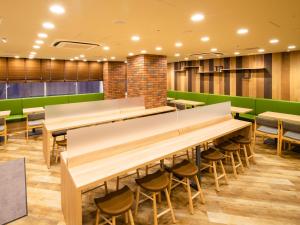 a restaurant with wooden tables and chairs at Super Hotel Sapporo Susukino in Sapporo +29 photos