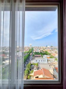 a view of a city from a window at Swiss-Belinn Manyar in Surabaya