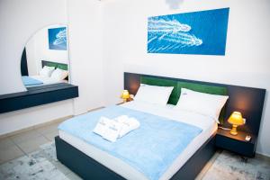 a bedroom with a bed with two towels on it at Gjuhadol stay by Marina in Shkodër