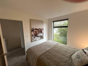 a bedroom with a bed and a large window at Luxury 2 Bedroom Hideout Near CBD,Merivale Mall in Christchurch