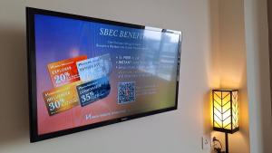 a flat screen tv hanging on a wall at Swiss-Belinn Tunjungan Surabaya in Surabaya