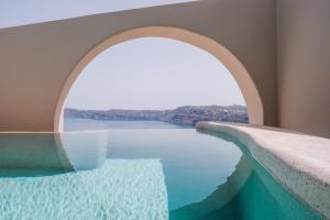 a swimming pool with a view of the water at Akrorama private villas and suites in Akrotiri +123 photos