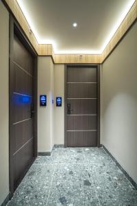 an empty corridor with two doors in a building at TK Phu Quoc Hotel - Grand World Phu Quoc in Phu Quoc