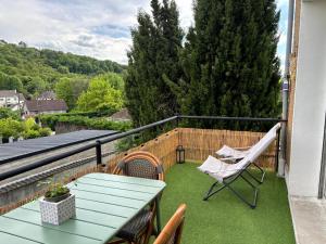 a patio with a table and chairs on a balcony at La terrasse de Sancerre in Saint-Satur