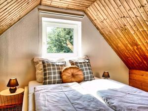 a bedroom with a bed and a window at Ferien im Fachwerkhaus mit Heimkino & Fitnessraum & Pools in Burgwedel +32 photos
