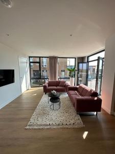 a living room with a couch and a rug at Nieuw-Brittenburg apartments I in Katwijk aan Zee