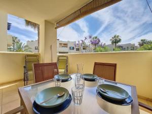 a table with plates and glasses on a balcony at Roda Golf Resort - 4010 in Roda