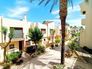 a palm tree in front of a building at Roda Golf Resort - 4010 in Roda