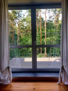 an open window with a view of a porch at Apartament w Willii Szmaragd in Borne Sulinowo