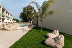 a resort with lounge chairs and a swimming pool at Thera luxury living in Nikiti