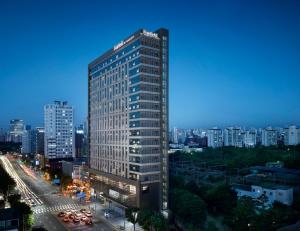 a tall building in the middle of a city at Fairfield by Marriott Seoul in Seoul