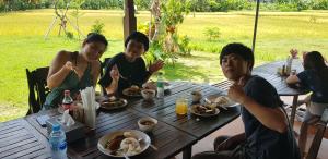 a group of people sitting at a table eating food at Villager's House Ubud in Gianyar