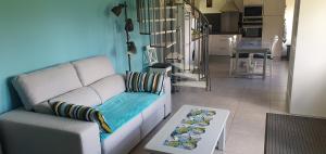 a living room with a couch and a table at La Pomme Verte in Authou