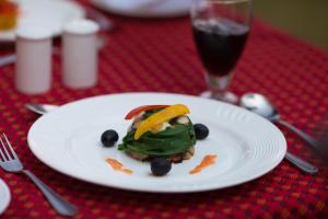 a plate of food on a table with a glass of soda at The Grand Imperial - Heritage Hotel in Agra
