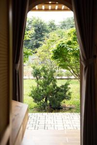 an open window with a view of a tree at B&H Villa - Villa has swimming pool in Lang Co