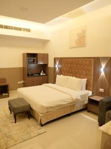 a bedroom with a large bed in a room at Dream Point Hotel in Fujairah