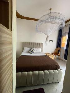 a bedroom with a bed and a chandelier at Noaz Hotel in Kampala