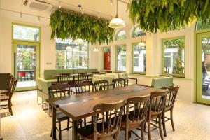 a restaurant with a large wooden table and chairs at B&H Villa - Villa has swimming pool in Lang Co