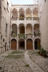 an alley with a large building with a balcony at Case Vacanza ARCO SANT'ANTONIO in Bisceglie