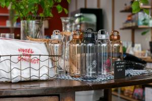 a group of glass bottles sitting on a table at KAMOME SLOW HOTEL the COMPACT in Awaji