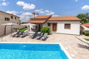 a villa with a swimming pool and a house at Villa Ajlin with Private Pool in Sveti Lovreč Pazenatički