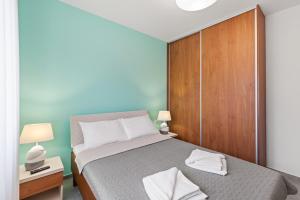 a bedroom with a bed and a wooden cabinet at Villa Ajlin with Private Pool in Sveti Lovreč Pazenatički +33 photos