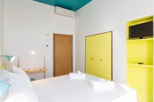 A bed or beds in a room at Hotel Belvedere Rimini