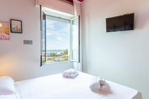 A bed or beds in a room at Hotel Belvedere Rimini