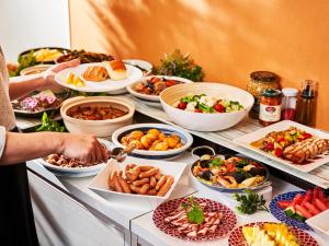 a buffet with many different types of food on a table at Kobe Sannomiya Union Hotel in Kobe