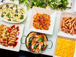 a table with plates of food on it at Kobe Sannomiya Union Hotel in Kobe