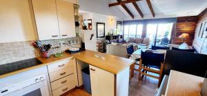 a kitchen with a counter and a dining room at Milkwood Lodge 10 - Sleeps 4 in Port Edward